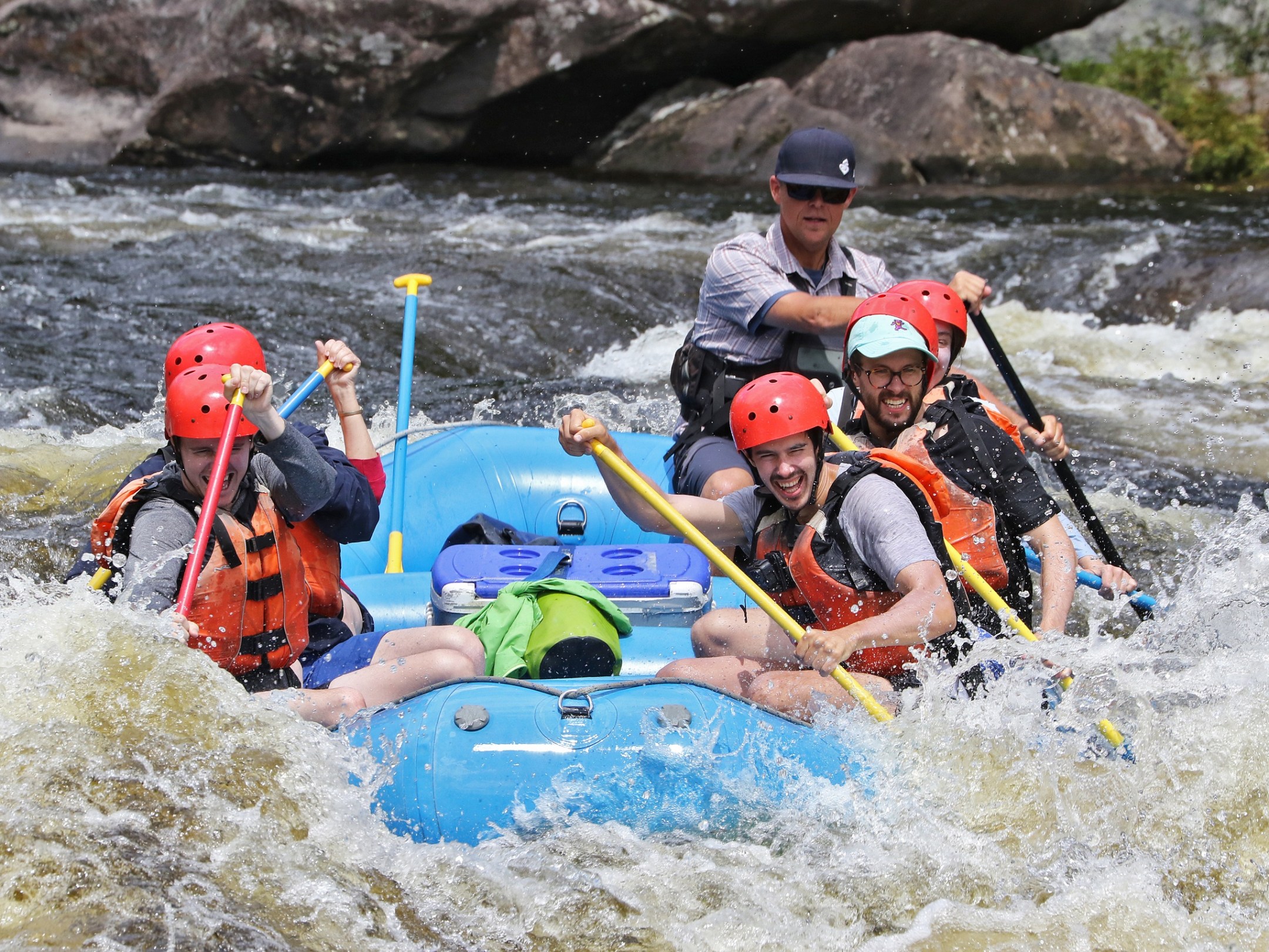 a group of people riding on a raft in a body of water