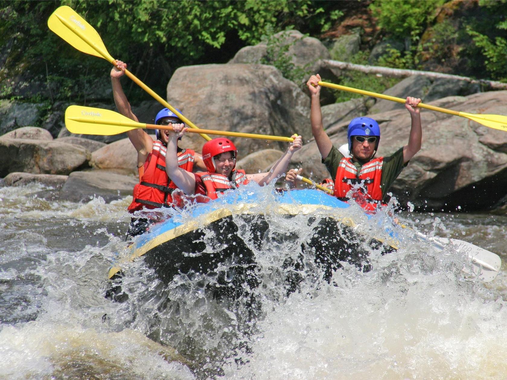a group of people on a raft in a body of water