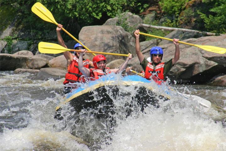 a group of people on a raft in a body of water