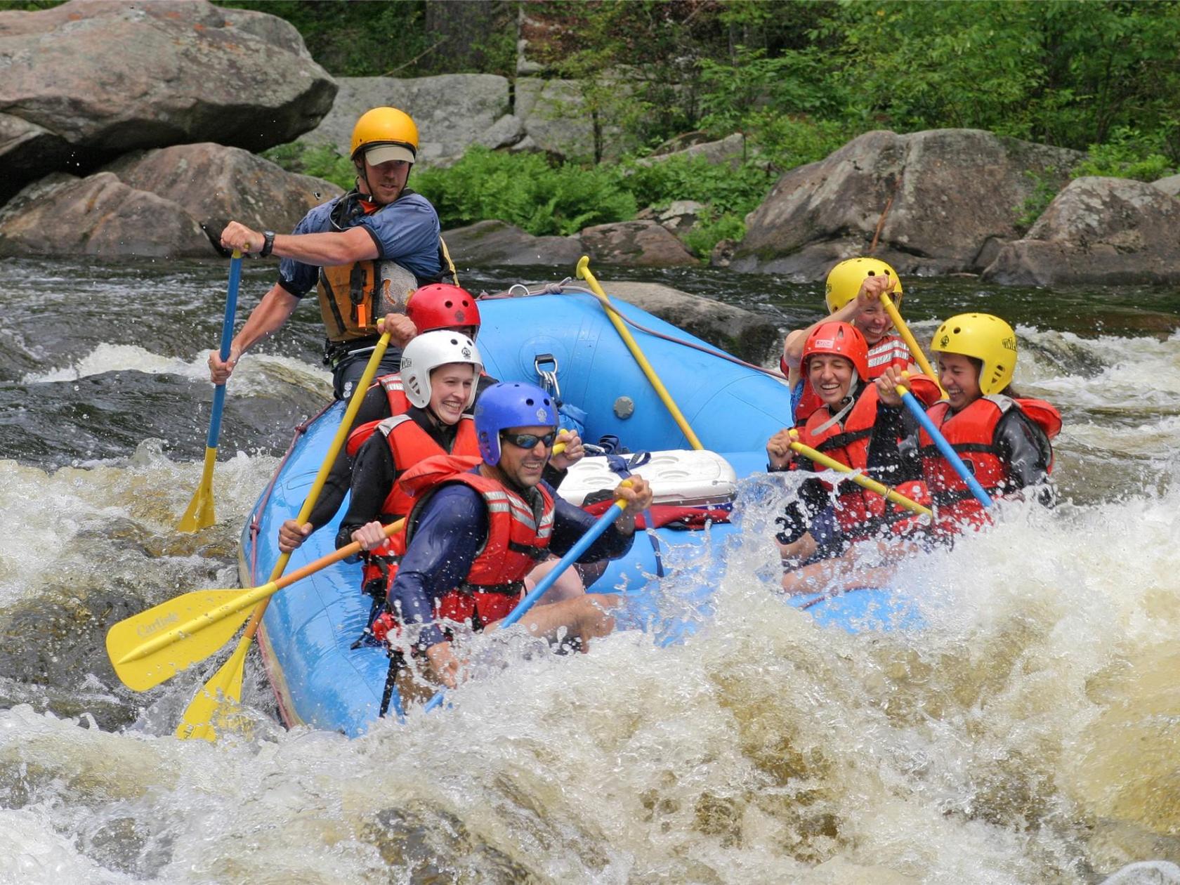 a group of people riding on a raft in a body of water