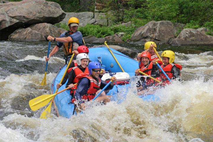 a group of people riding on a raft in a body of water