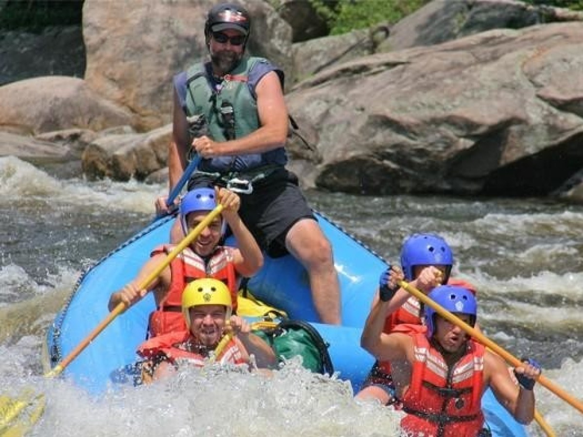 a man riding on a raft in a body of water