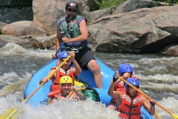 a man riding on a raft in a body of water